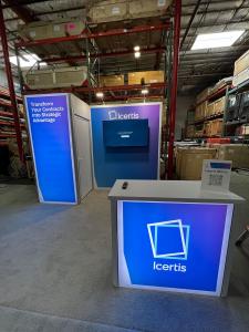 RENTAL: RE-1077 Gravitee System Inline Design with Storage Closet with Locking Door, Lightbox, Large Monitor Mount, 55 Inch Monitor, RE-1586 Backlit Reception Counter, (2) LED Arm Lights, and Silicone Edge Fabric Graphics