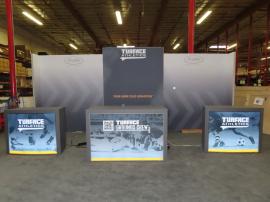 Custom Gravitee Modular Inline Exhibit with SEG Fabric Graphics, (3) Monitor Mounts, Closet Storage, (2) MOD-1509 Backlit Counter with Locking Storage, and (1) Custom Backlit Counter with Wireless Charging Pads